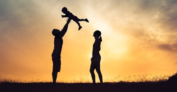 child lifted by parents