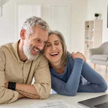 happy elderly couple on laptop computer