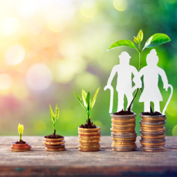 coins stacked with growing plant for retirement